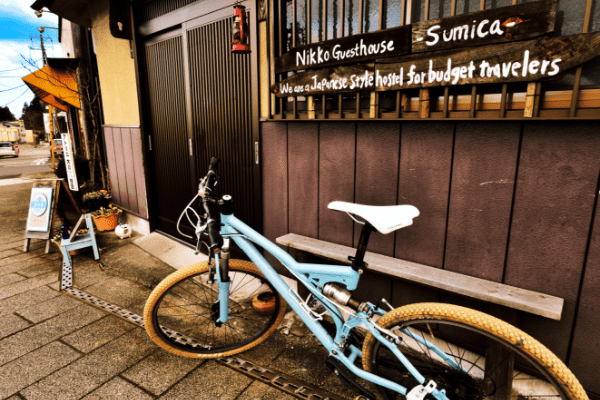 日光ゲストハウス巣み家の入り口に置かれた水色の自転車の写真