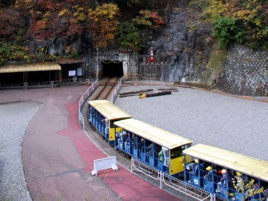 トロッコ電車が足尾銅山の入り口に向かって走っている写真