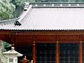 入母屋造で全体が朱色の二荒山神社拝殿左側部分をアップで写した写真